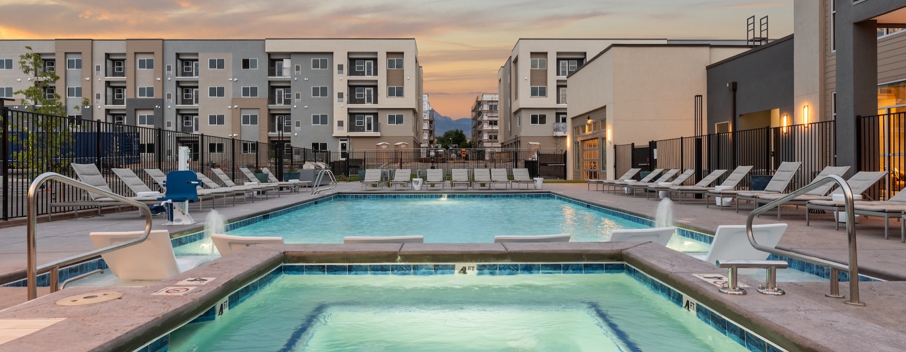 Resort-style swimming pool with lounge seating