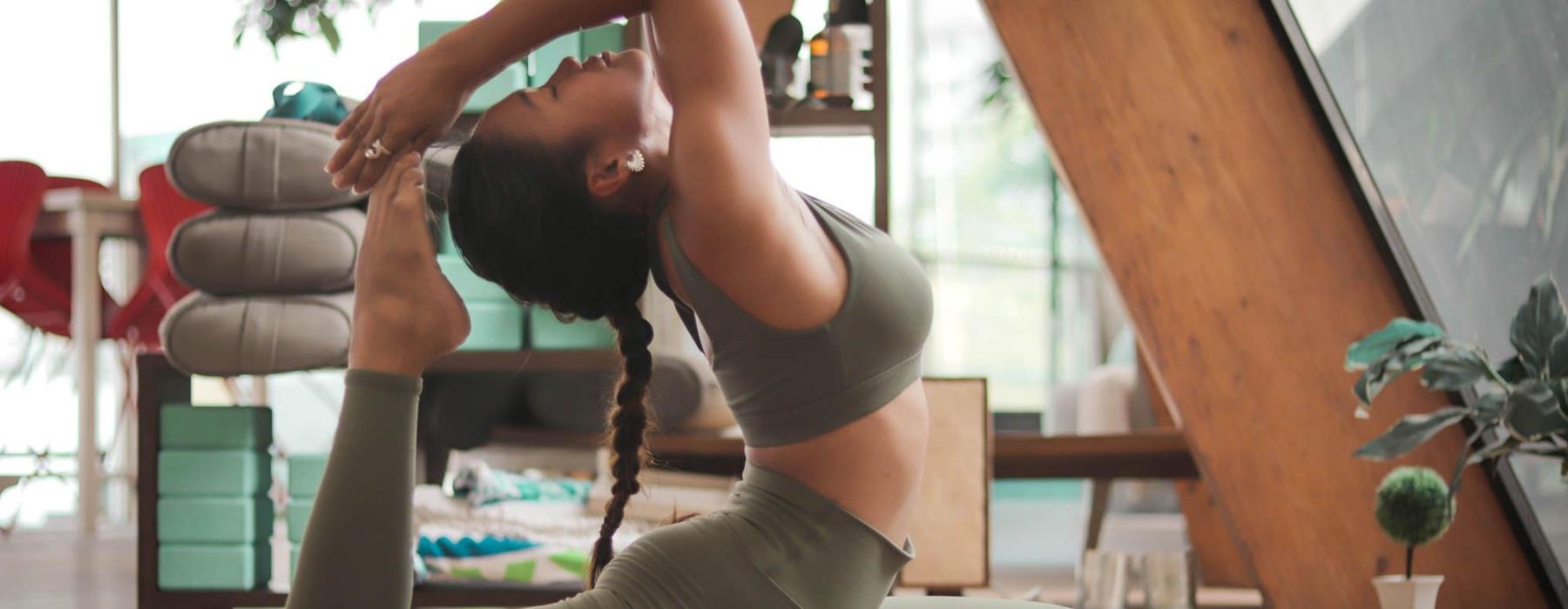 a woman doing yoga on mat